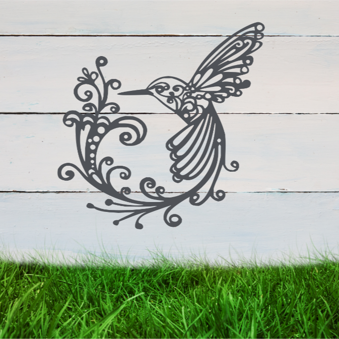 Delicate metal wall art featuring a hummingbird with intricately detailed wings and tail, surrounded by swirling vine patterns, finished in Berry Grey Gloss powder coating, mounted on a rustic white wooden backdrop, perfect for adding a touch of nature to an outdoor space.