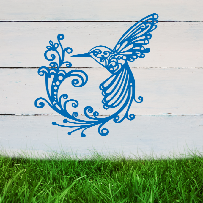 Delicate metal wall art featuring a hummingbird with intricately detailed wings and tail, surrounded by swirling vine patterns, finished in Blaze Blue Gloss powder coating, mounted on a rustic white wooden backdrop, perfect for adding a touch of nature to an outdoor space.