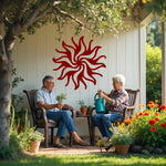 Twilight Radiance metal wall art in Manor Red, highlighting a bold red sun-inspired design that creates a statement piece for outdoor and indoor walls.